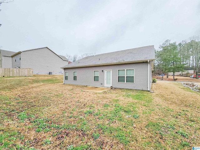 rear view of property with a yard