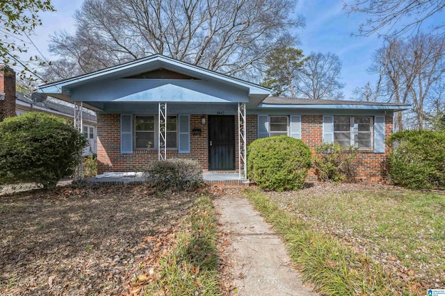 bungalow-style house featuring a porch and brick siding