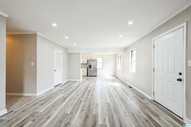 unfurnished living room with light wood-style floors, baseboards, ornamental molding, and recessed lighting