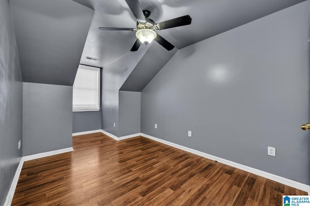 additional living space with lofted ceiling, baseboards, visible vents, and wood finished floors