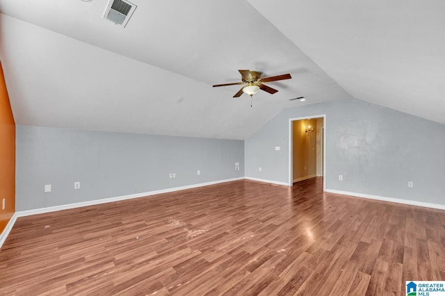 additional living space featuring a ceiling fan, wood finished floors, visible vents, and baseboards