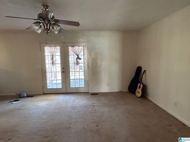 spare room with french doors, carpet, and ceiling fan