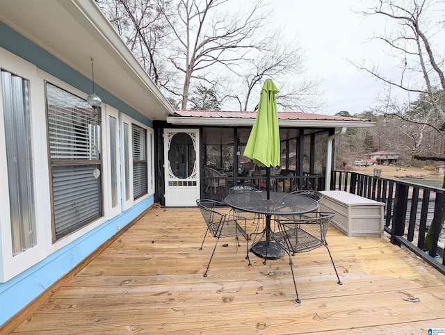 wooden deck featuring a sunroom