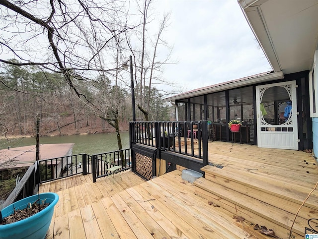 wooden deck with a water view and a sunroom