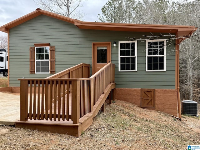 exterior space with cooling unit and a wooden deck