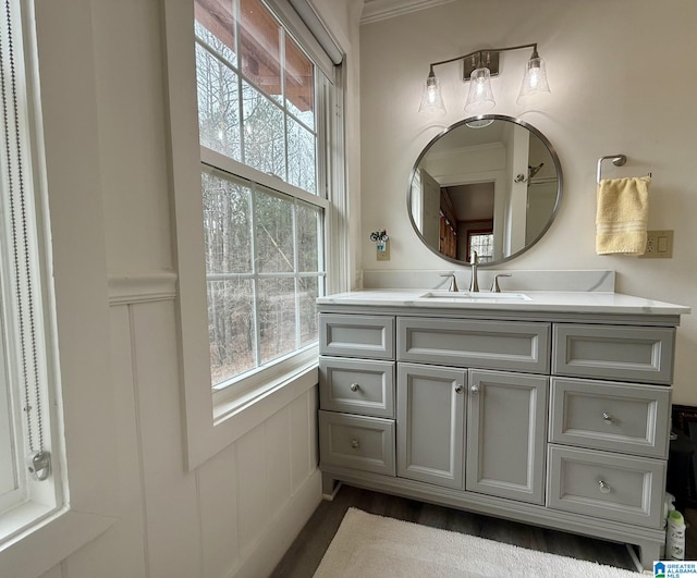 bathroom with ornamental molding and vanity