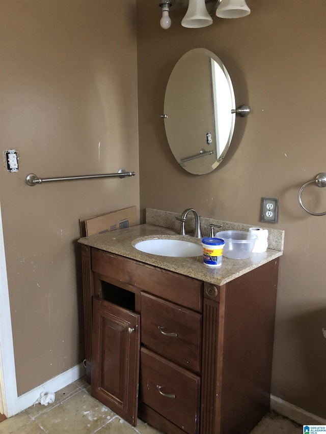 bathroom with tile patterned floors, vanity, and baseboards