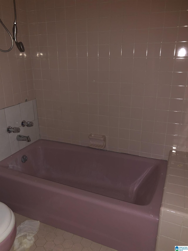 full bathroom featuring tile patterned flooring and toilet