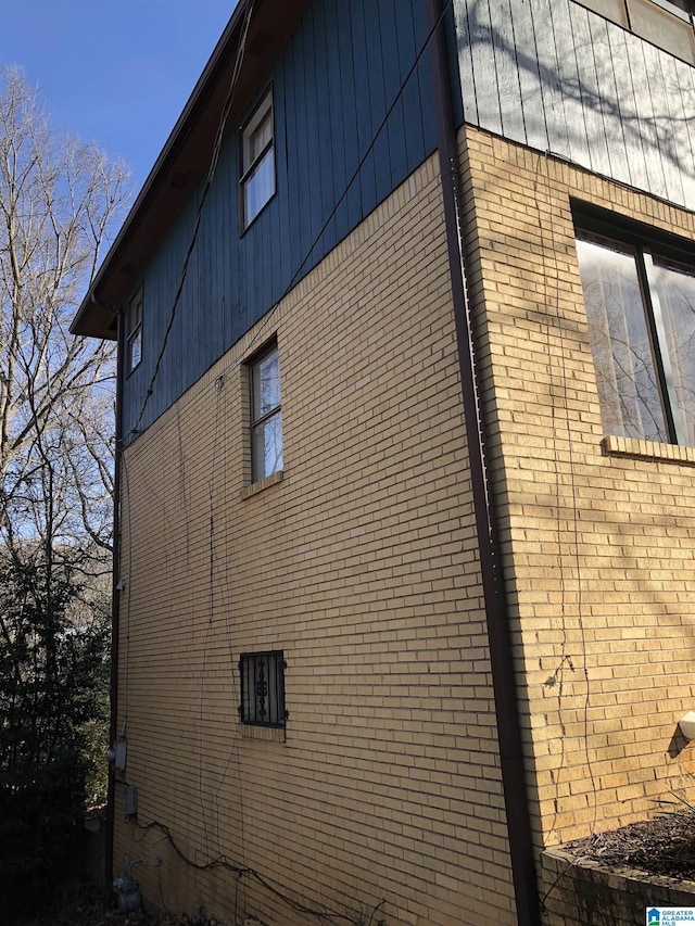 view of side of property with brick siding