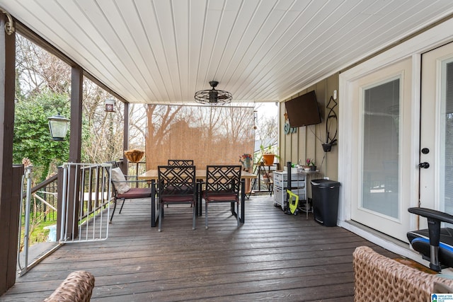 deck with outdoor dining area and ceiling fan