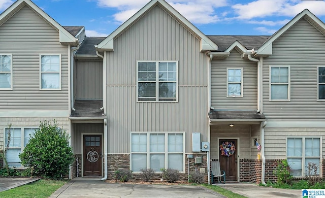 townhome / multi-family property featuring brick siding