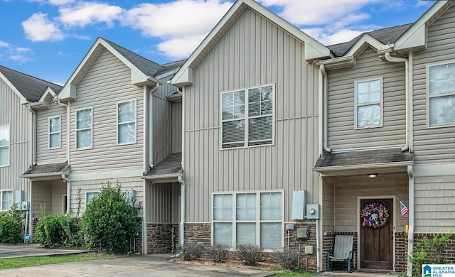 multi unit property with stone siding and roof with shingles