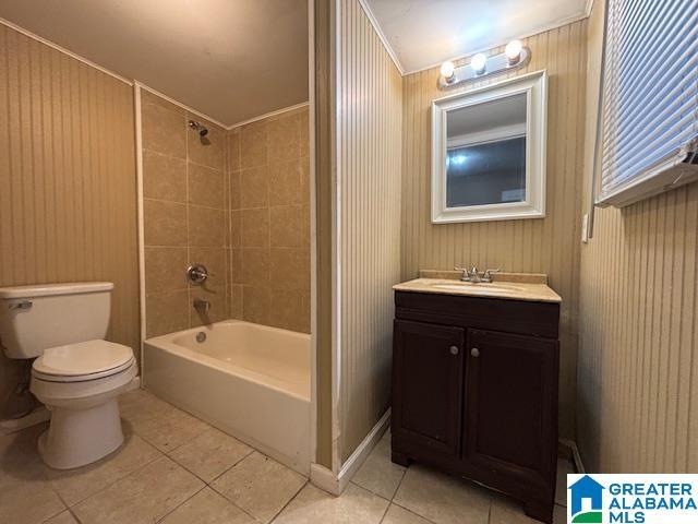 bathroom featuring shower / bath combination, toilet, wood walls, vanity, and tile patterned floors