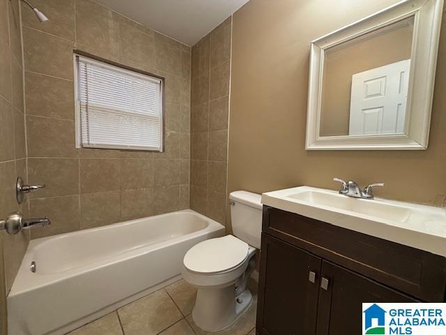 bathroom featuring shower / washtub combination, vanity, toilet, and tile patterned floors