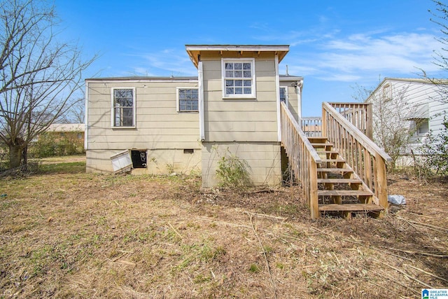 rear view of property with crawl space, stairway, and a deck