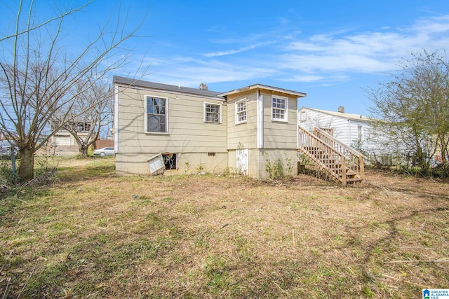 exterior space featuring stairs and a yard