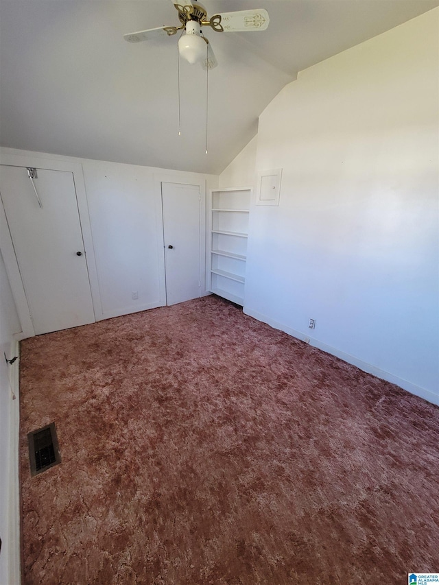 unfurnished bedroom with lofted ceiling, ceiling fan, visible vents, and carpet flooring