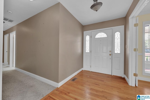 entryway featuring visible vents, light wood-style flooring, and baseboards