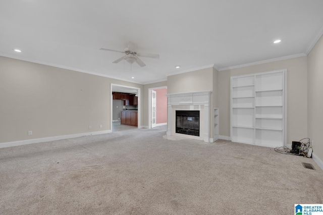 unfurnished living room with baseboards, a fireplace with flush hearth, visible vents, and light colored carpet