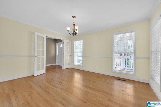 unfurnished dining area with a wealth of natural light, french doors, light wood-style flooring, and visible vents