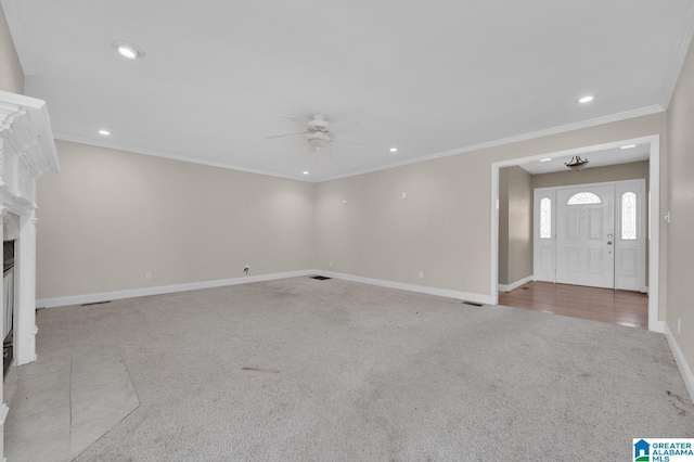 unfurnished living room featuring crown molding, a fireplace, carpet flooring, and baseboards