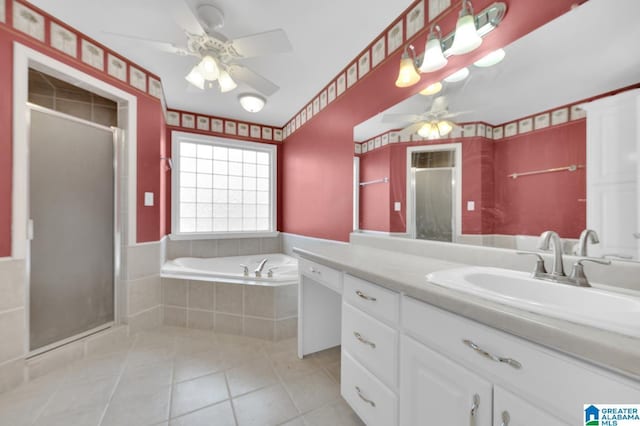 bathroom with a garden tub, a stall shower, tile patterned flooring, and vanity