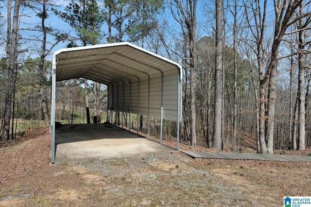 view of parking with dirt driveway and a carport