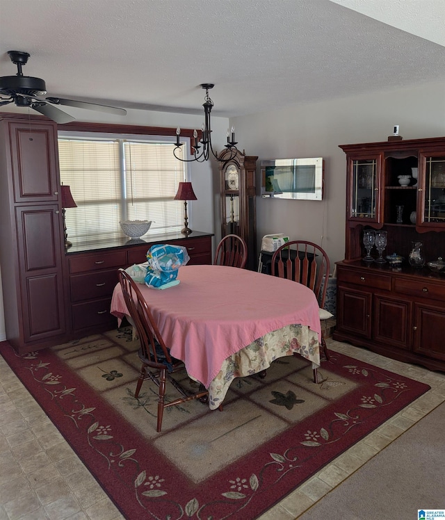 dining room with a textured ceiling, a ceiling fan, and light floors