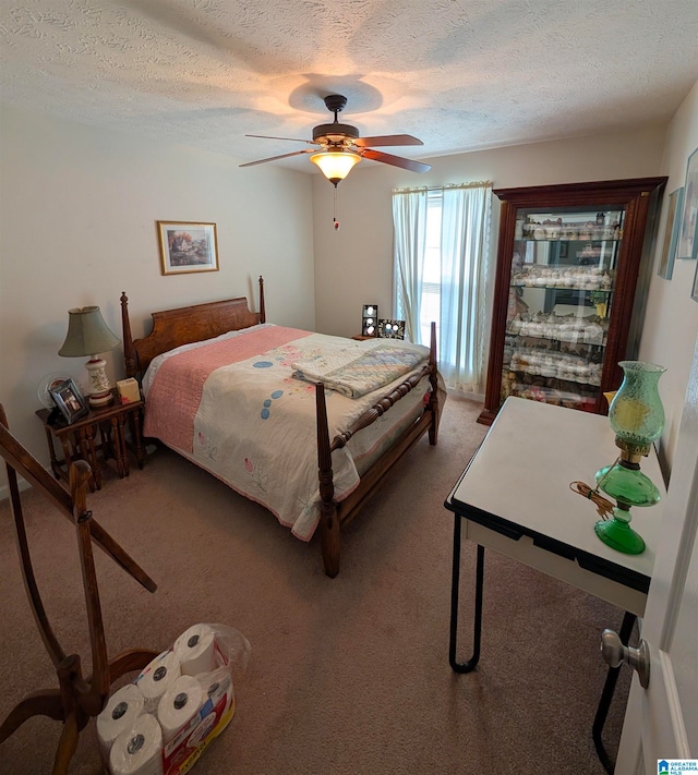 bedroom with a textured ceiling, ceiling fan, and light colored carpet