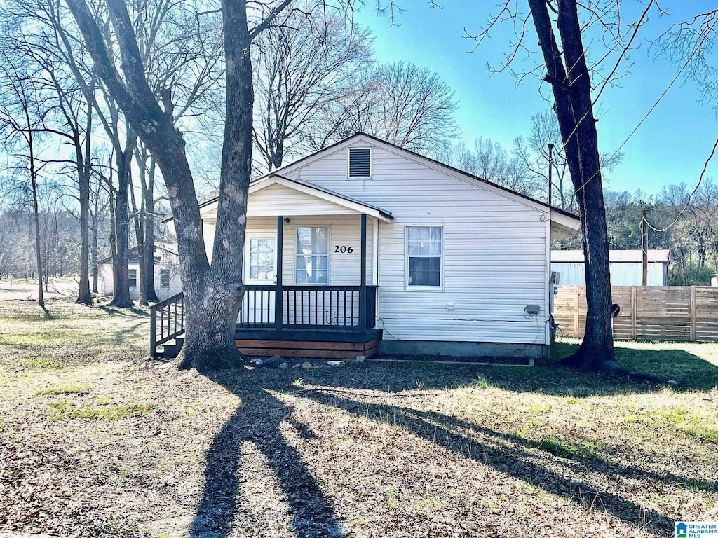 bungalow with a porch and fence