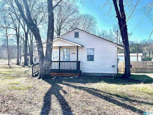 bungalow with a porch and fence