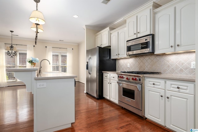 kitchen featuring appliances with stainless steel finishes, dark wood-style flooring, crown molding, white cabinetry, and a sink