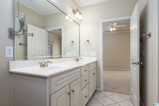 bathroom featuring double vanity, tile patterned flooring, a sink, and crown molding