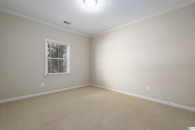 spare room with light carpet, baseboards, visible vents, and crown molding