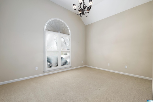 unfurnished room featuring a chandelier, light colored carpet, vaulted ceiling, and baseboards