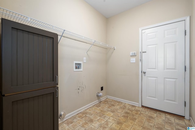 laundry area featuring laundry area, stone finish floor, hookup for a washing machine, and baseboards