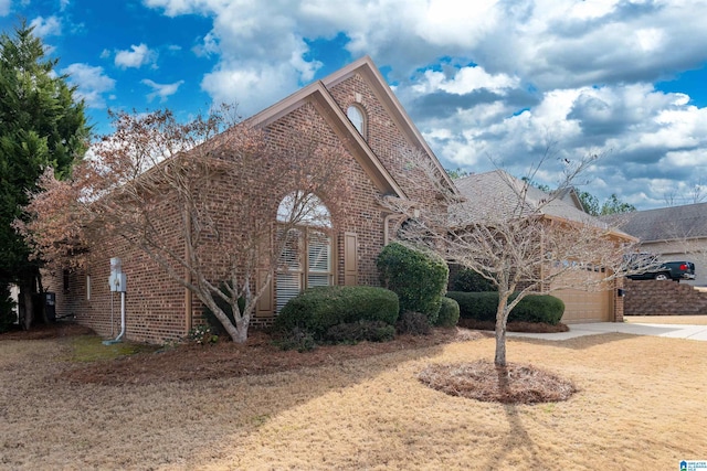 view of front of property with a garage, brick siding, and driveway