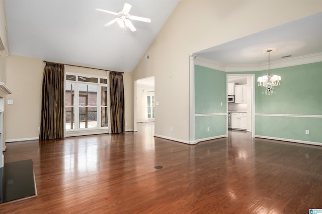 unfurnished living room featuring ceiling fan with notable chandelier, high vaulted ceiling, wood finished floors, and baseboards