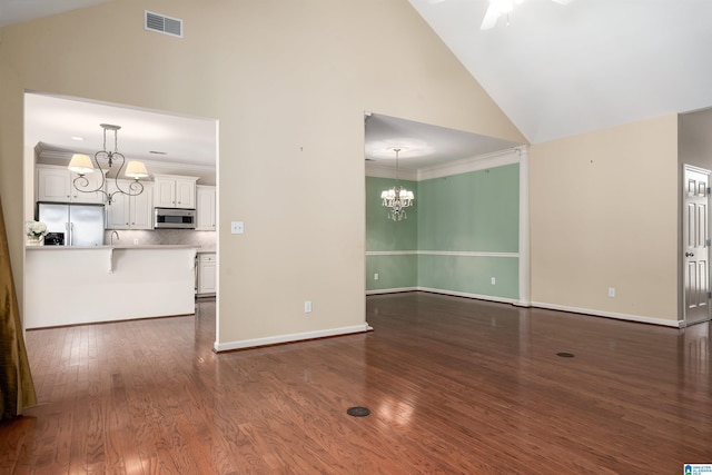 unfurnished living room with ornamental molding, dark wood-style flooring, visible vents, and baseboards