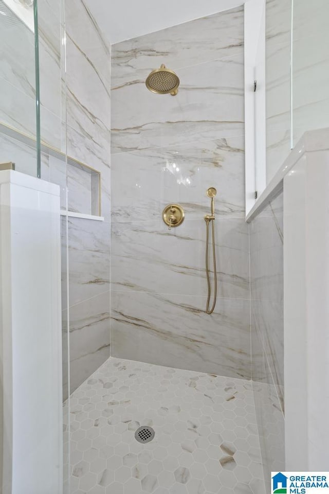 full bathroom featuring a marble finish shower