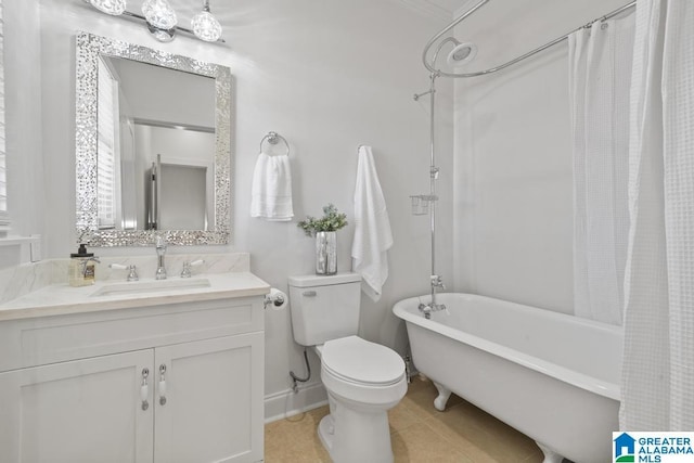 bathroom with tile patterned flooring, vanity, and toilet