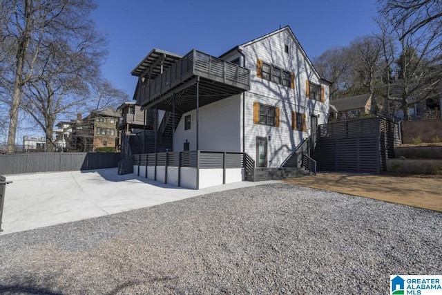 contemporary home featuring fence