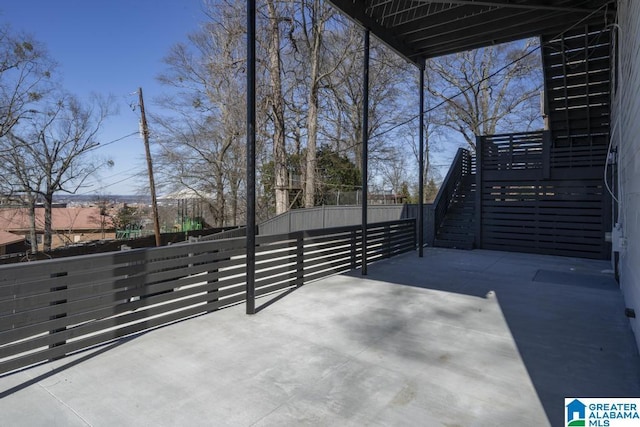 view of patio / terrace with fence and stairway