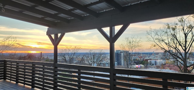 deck at dusk featuring a city view