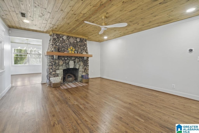 unfurnished living room featuring a fireplace, wood finished floors, wood ceiling, visible vents, and baseboards