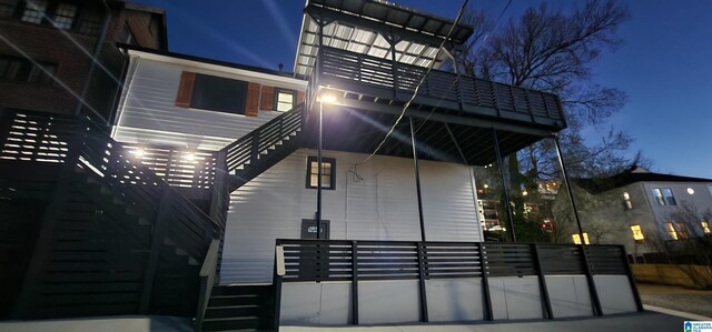 view of back of house at night