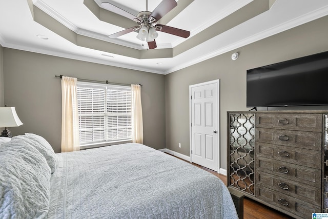 bedroom with dark wood-style floors, crown molding, a raised ceiling, visible vents, and ceiling fan