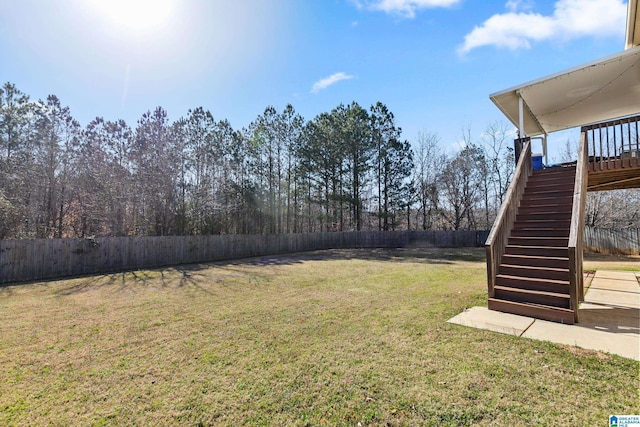 view of yard with stairs and a fenced backyard