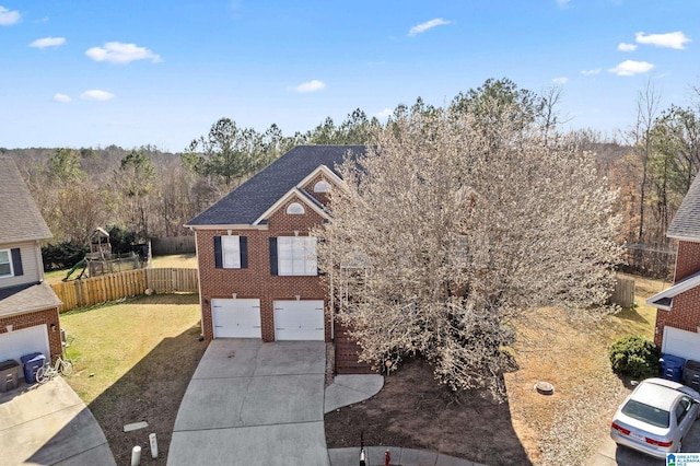 view of front facade featuring a garage, brick siding, fence, driveway, and a front yard