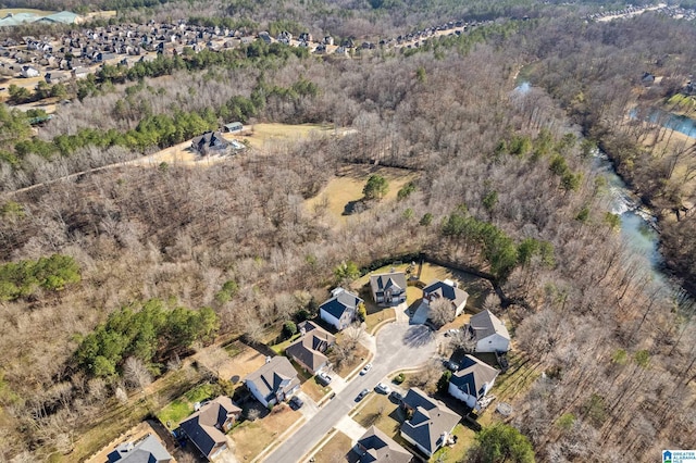 drone / aerial view with a forest view and a residential view